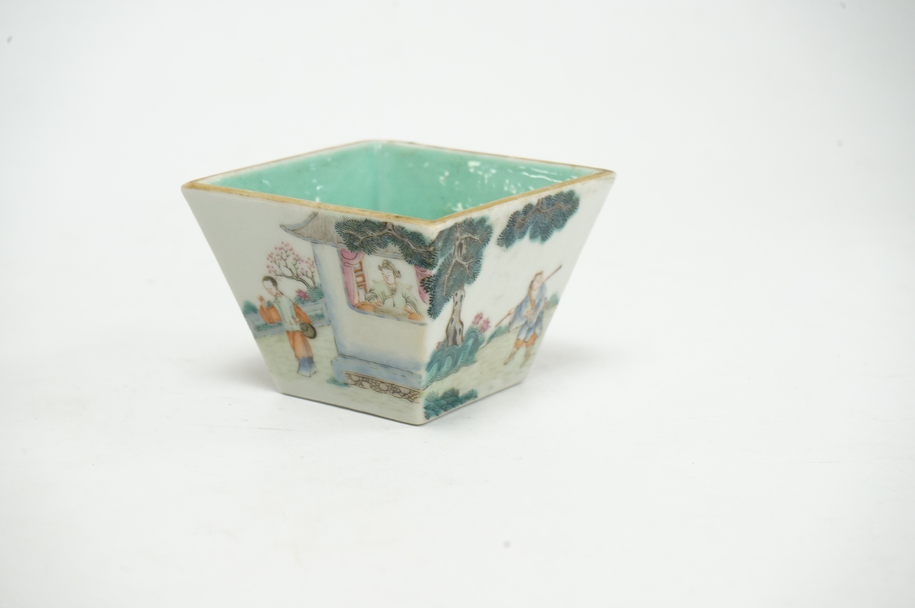 A Chinese famille rose small square bowl, Qianlong seal mark but Daoguang period (1821-50), finely painted with figures in a garden, the interior with turquoise glaze, iron red six character mark to base, 7.5cm wide. Con